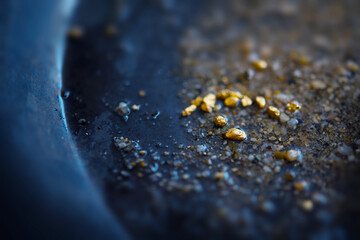 Gold dIscovery. Gold on grungy wash pan with river sand. Gold panning or digging. Very shallow...