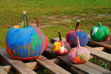 Round orange pumpkins painted by children for Halloween