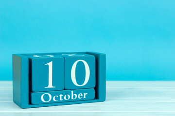 wooden calendar with the date of October 10 on a blue wooden background, World Porridge Day; World Homeless Day; World Day Against the Death Penalty; World Mental Health Day	