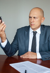 The man in the suit got the bad news on the phone, on the Internet.