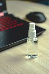 disinfectant in a clear bottle, laptop cleaning, close-up