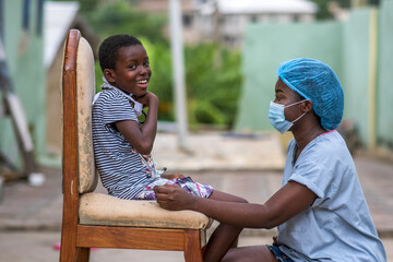 Closeup shot of a boy and a doctor wearing sanitary mask