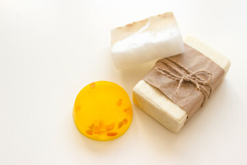 Pieces of handmade soap on a white background. View from above.