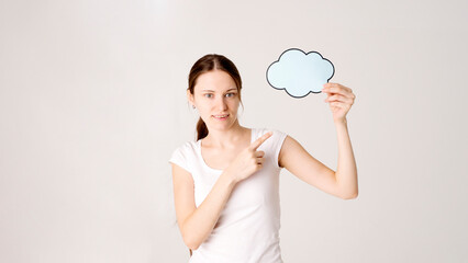 mid adult woman holding blank speech bubble on white background. Horizontal shape, front view, waist up, copy space