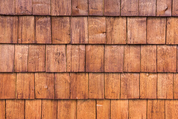 Rough bumpy light wood paneling, a series of wooden materials from the facade of a small tile.