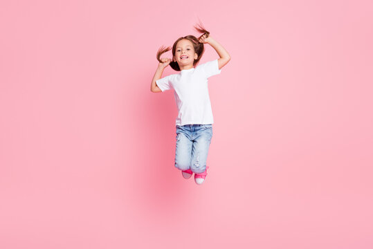 Silky smooth haircut salon therapy good even kids ads concept, Full body photo of lovely child girl jump hold hands her hair wear denim white t-shirt isolated pastel color background