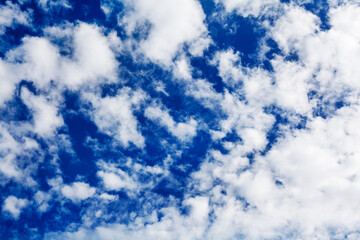White cirrus clouds blue sky background close up, fluffy cumulus cloud texture, beautiful...