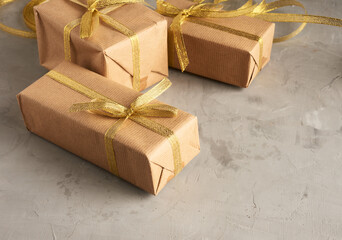 rectangular box wrapped in brown paper and tied with a silk ribbon with a bow