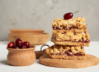 stack of baked crumble pie with fruit filling and sprinkled with grated almonds