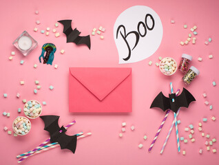 Halloween decorations on pink background. Halloween holiday concept. Flat lay, top view