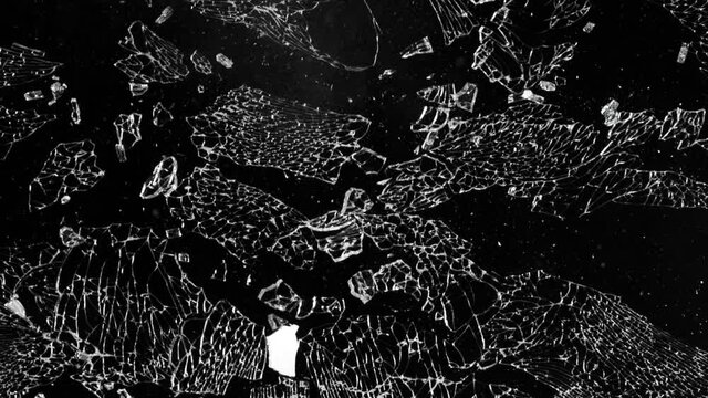 Super slow motion of shattered glass on black background. Filmed on high speed cinema camera, 1000 fps.