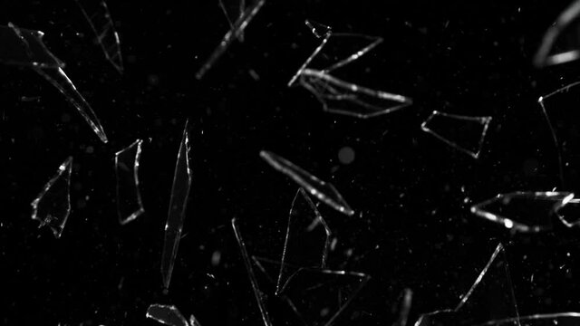 Super slow motion of shattered glass on black background. Filmed on high speed cinema camera, 1000 fps.