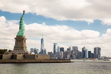 Statue of Liberty National Monument on a cloudy day with the New York skyline in the background. Liberty Island, New York, United States © Gloria