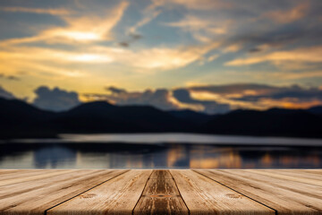 Showcase an old wooden table shelf on a beautiful sunset and blurred nature background.