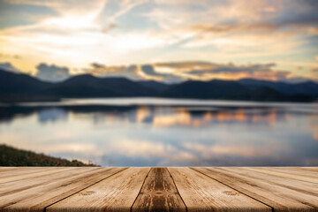 Fototapeta na wymiar Showcase an old wooden table shelf on a beautiful sunset and blurred nature background.