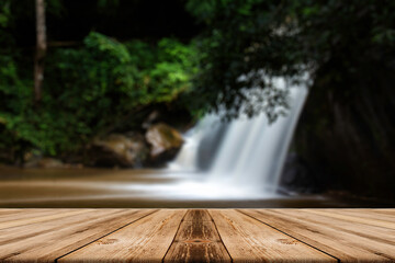 The empty wooden table above the waterfall view.