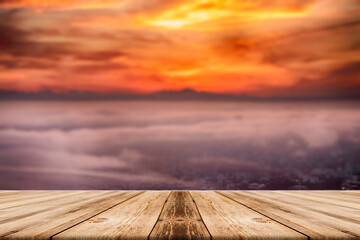 Fototapeta na wymiar Showcase an old wooden table shelf over a beautiful sunrise and blurred nature background.