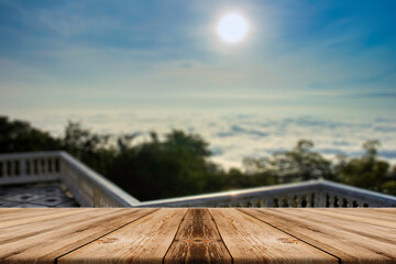 Naklejka na ściany i meble Showcase an old wooden table shelf over a beautiful sunrise and blurred nature background.