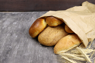 Bakery product and wheat ears in a paper bag