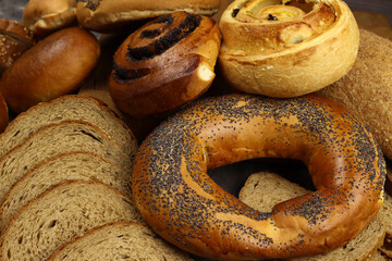 Bakery product assortment with loaves of bread, rolls, bagels and wheat ears