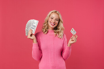 Image of cheerful blonde woman posing with dollars and credit card