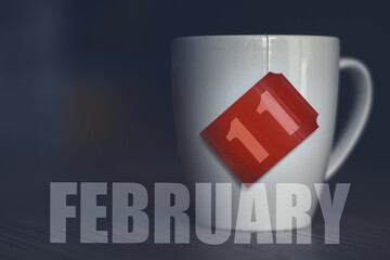 february 11th. Day 11 of month,Tea Cup with date on label from tea bag. winter month, day of the year concept