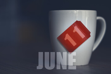 june 11th. Day 11 of month,Tea Cup with date on label from tea bag. summer month, day of the year concept