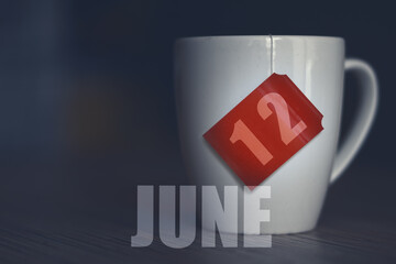june 12th. Day 12 of month,Tea Cup with date on label from tea bag. summer month, day of the year concept