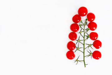 cherry tomatoes in the shape of a christmas tree on a white background with space for text