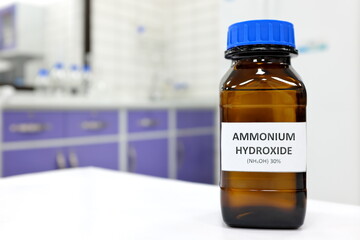 Selective focus of ammonium hydroxide or ammonia solution in glass amber bottle inside a chemistry...