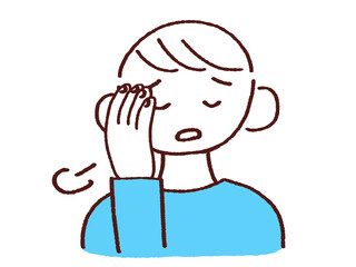 頭を抑えてため息をつく若い男性