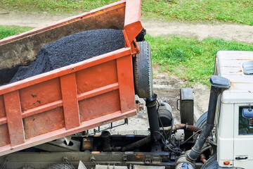 truck body pours asphalt, gravel