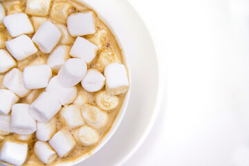 Coffee with marshmallows on a white background.Hot winter drink.