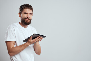 emotional man with tablet in hand touch screen new technologies light background cropped view Copy Space