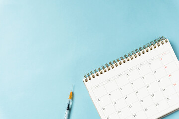 Syringe and calendar.  Vaccinations, medicines, vaccines, flu injections, illnesses, antibiotics,...