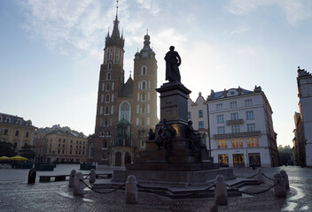 Cracow, the Adam Mickiewicz monument in Main Market Square with St. Mary's Basilica in background
