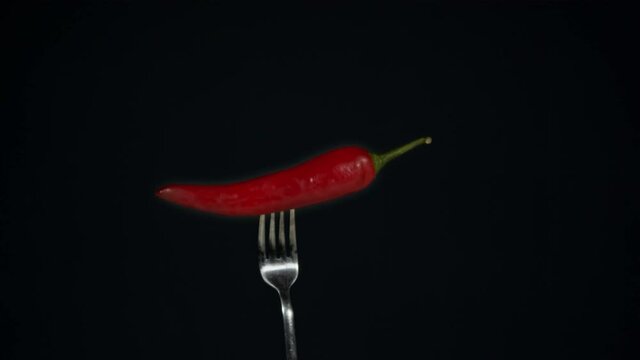 Red hot chili pepper burns on black background