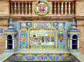 Fototapeta na wymiar Image with the name of the spanish city of Barcelona painted on ceramic tiles and the emblem shield - seating benches in Spain Square in Seville