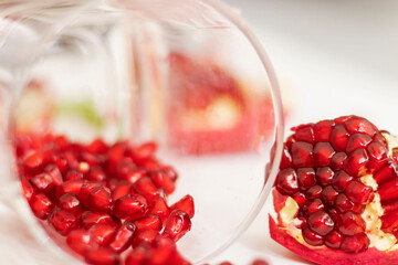 Pomegranate fruit on a white background and mint leaves