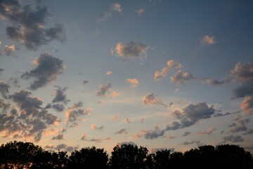 scattered clouds in mauve and pink sky at sunset