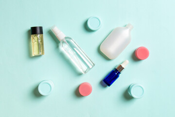 Cosmetics SPA branding mock-up, top view with copy space. set of tubes and jars of cream flat lay on colored background