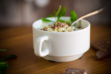 sweet noodles with milk and grated chocolate in a bowl