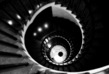 Spiral staircase top view, selected focus, black and white photo.