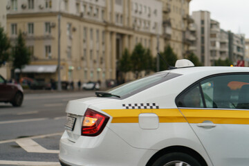 Photography of rain day in the city Moscow and bumper of yellow taxi car. Big traffic at highway....