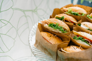 A group of homemade HAMBURGER is wrapped with paper craft and arranged on the dish, ready to serve and eat.