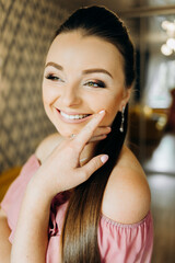 Portrait of a cute woman in a pink dress.