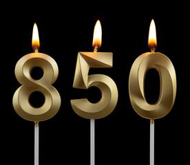 Gold birthday candles on black background, number 850	