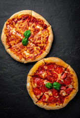 Pepperoni Pizza and Pizza with Mozzarella cheese, Tomatoes, pepper, olive, Spices and Fresh basil. Pizza Margherita or Margarita on Dark grey black slate background