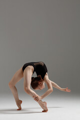 Young gymnast girl stretching and training