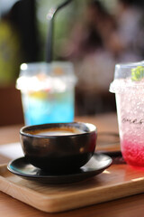 A glass of Italian soda and a cup of Cappucino on the wooden table